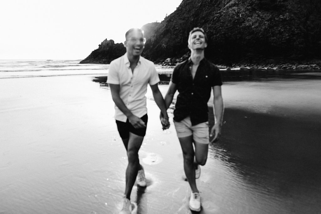 messy out of focus fun and candid moody engagement photos oregon coast black and white