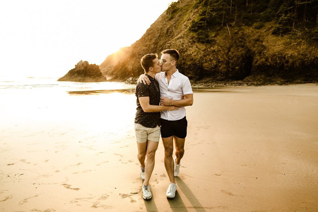 oregon coast photographer engagement session at cannon beach location idea couple walking on the beach