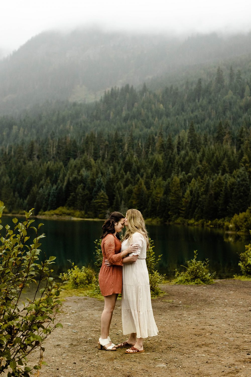 Couple embraces during their fall engagement photos at Gold Creek Pond in Snoqualmie Pass