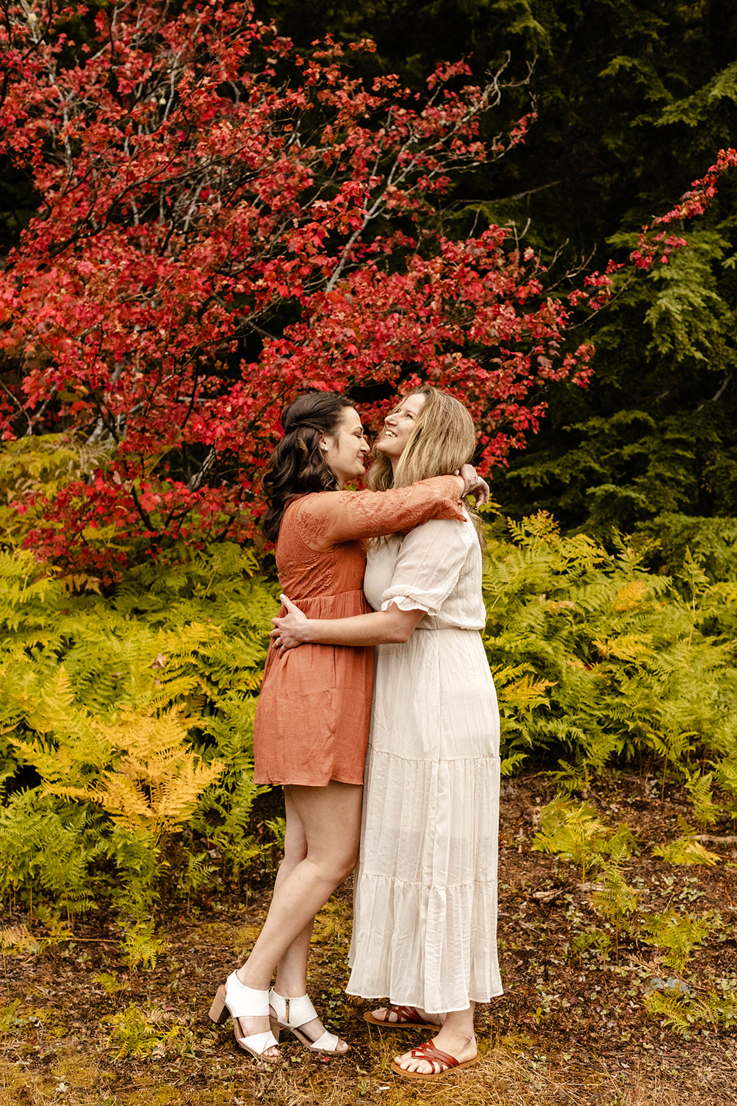 couple leaning in for a hug at their fall engagement photos at Gold Creek Pond