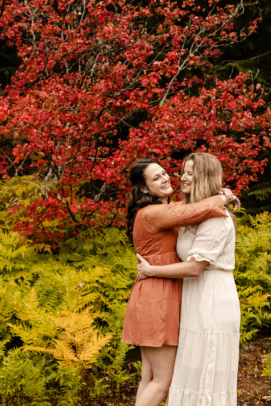 couple leaning in for a hug at their fall engagement photos at Gold Creek Pond