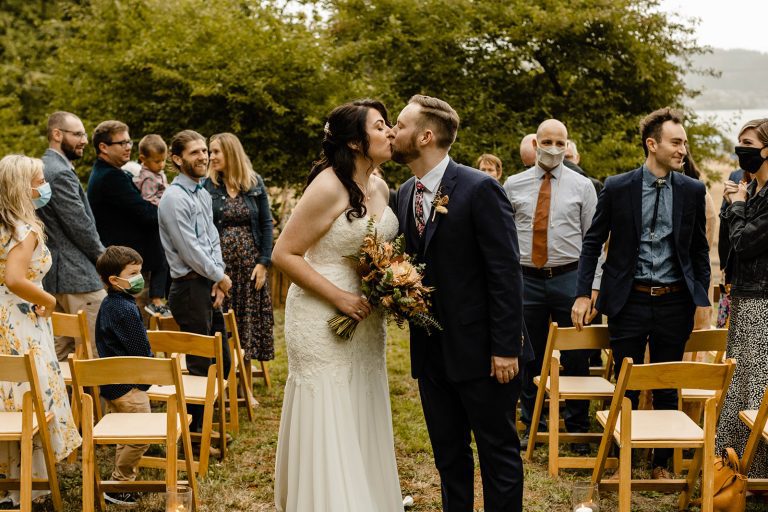 backyard wedding moments, ceremony aisle kiss
