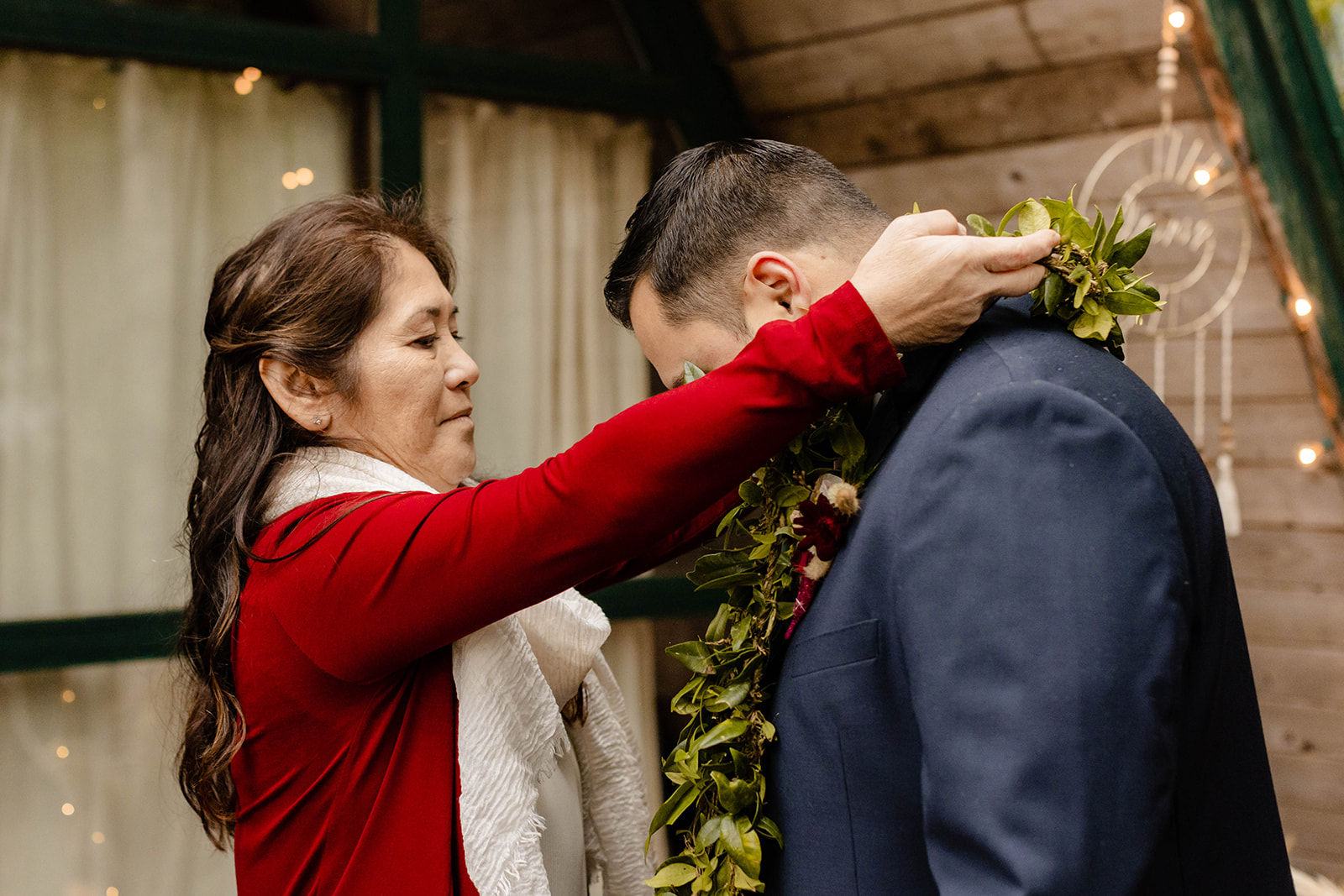 Tia's mother gives Wil a haku after the ceremony.