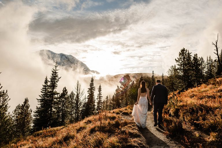 couple walks down the trail in the sunrise region of Mount Rainier national park for their elopement