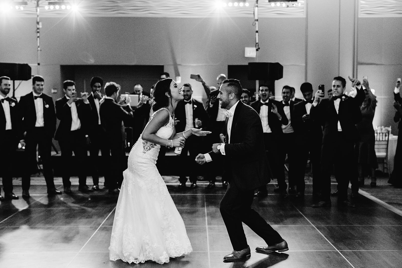 Black and white photo of couple dancing at their reception.