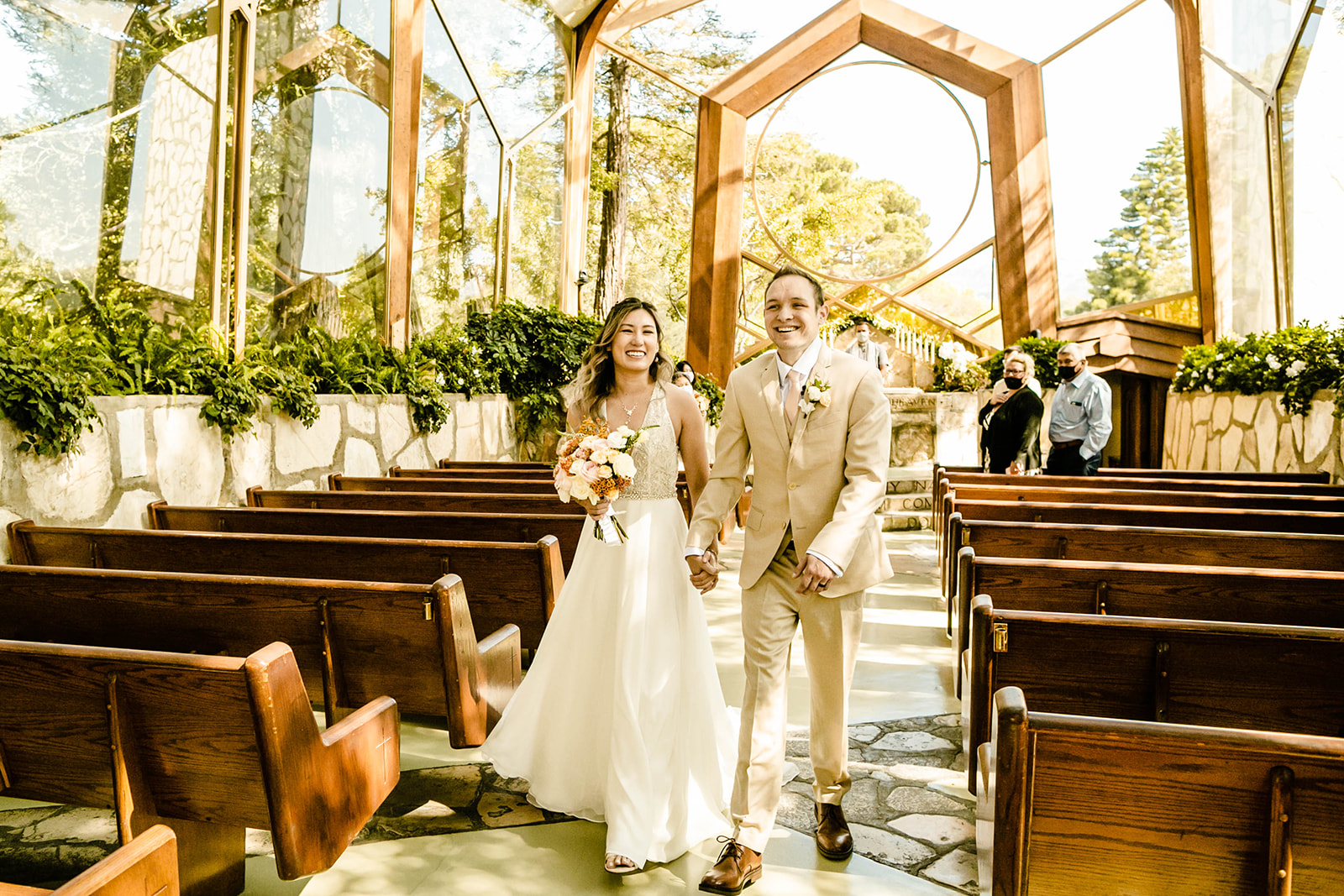 Couple leaves ceremony in Wayfarers Chapel, one of 31 Los Angeles wedding venues I recommend. 