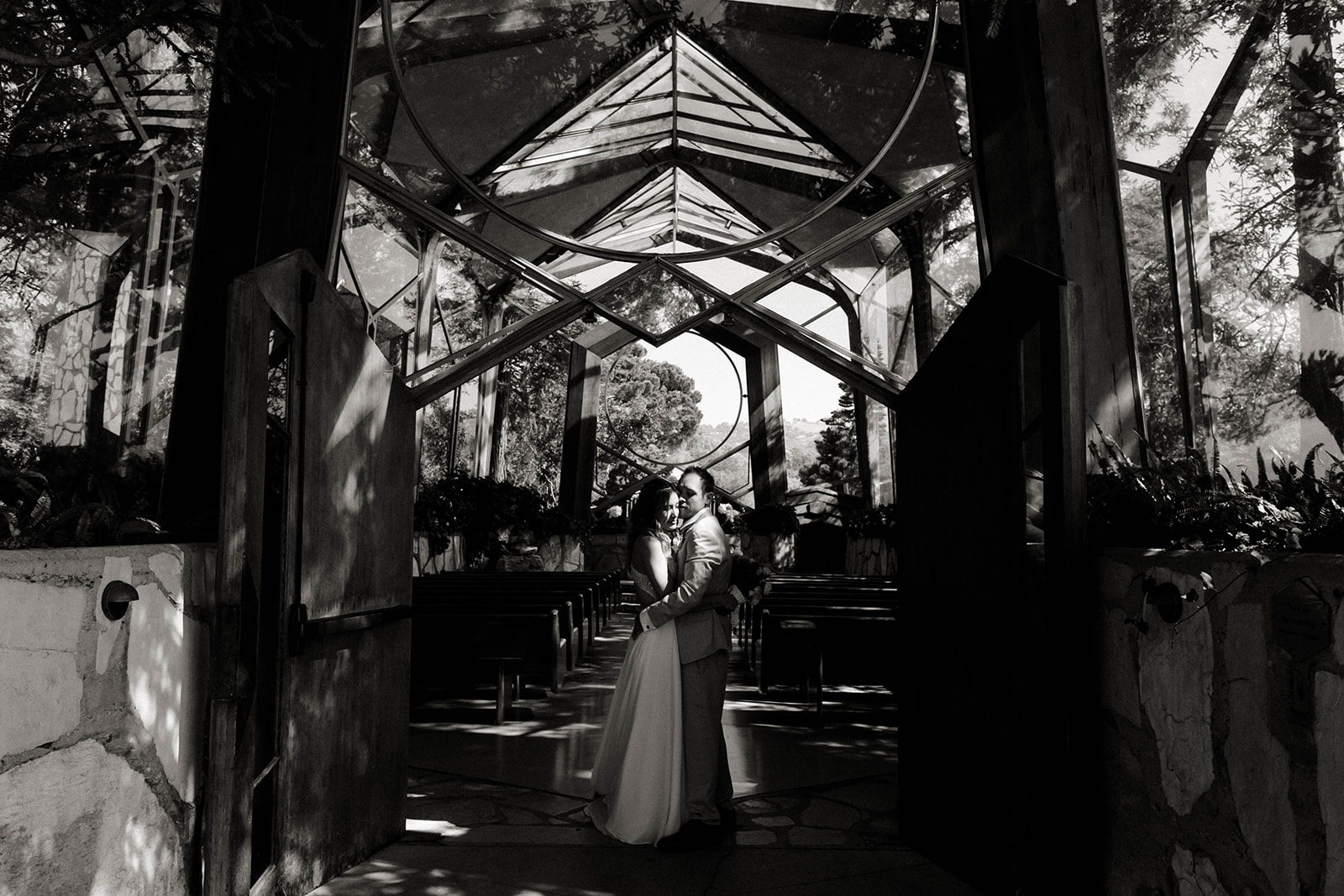 Couple kisses in Wayfarers Chapel, one of 31 Los Angeles wedding venues I recommend. 