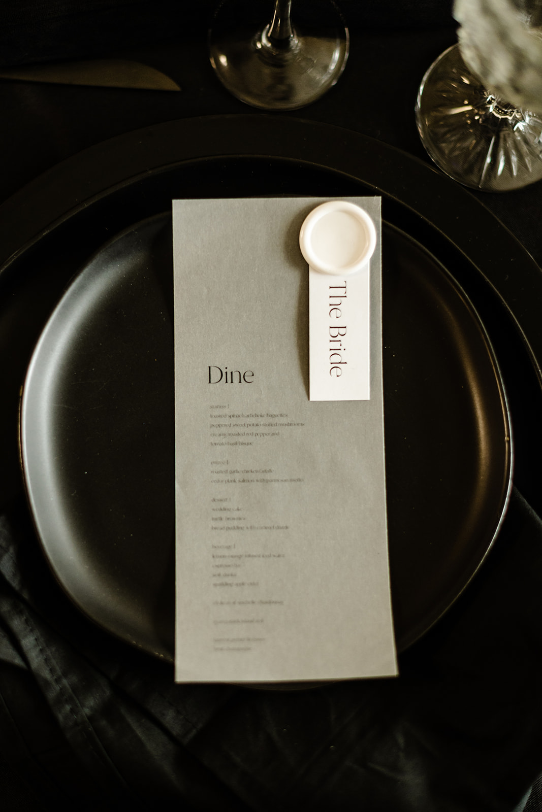 Black ceramic dinnerware and menu for an all black wedding theme