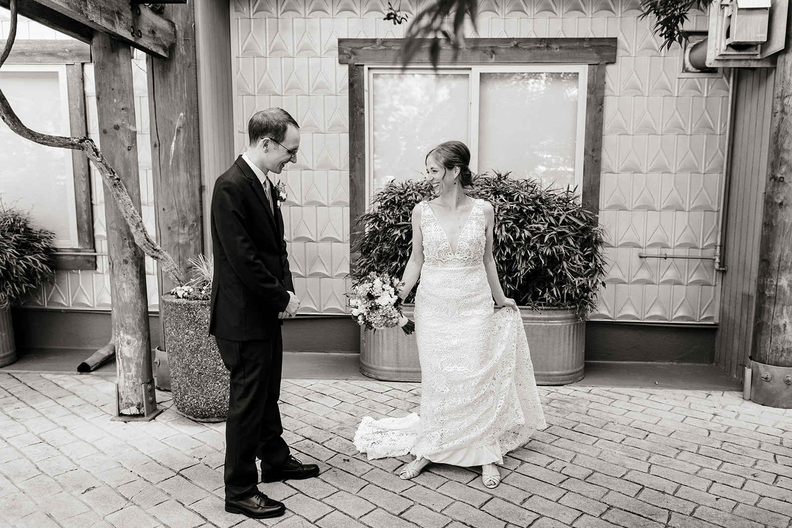 bride shows off her dress by twirling. black and white.