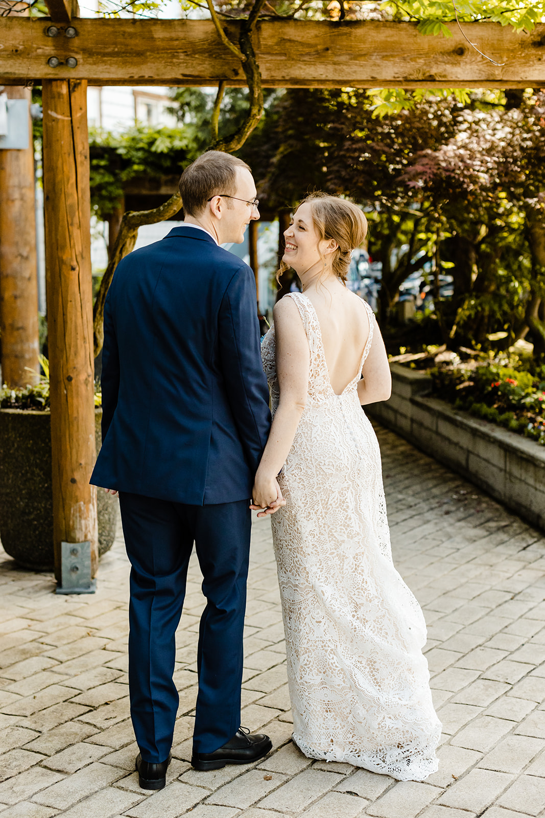 couple walks along brick path.