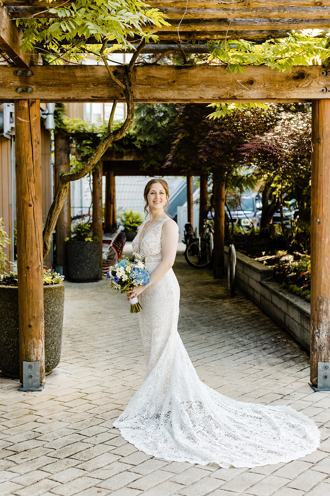 bride poses under a trellis for a few portraits.