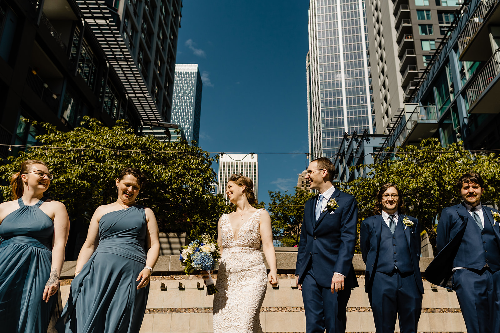 couple and wedding party walk toward the camera in downtown seattle. low angle