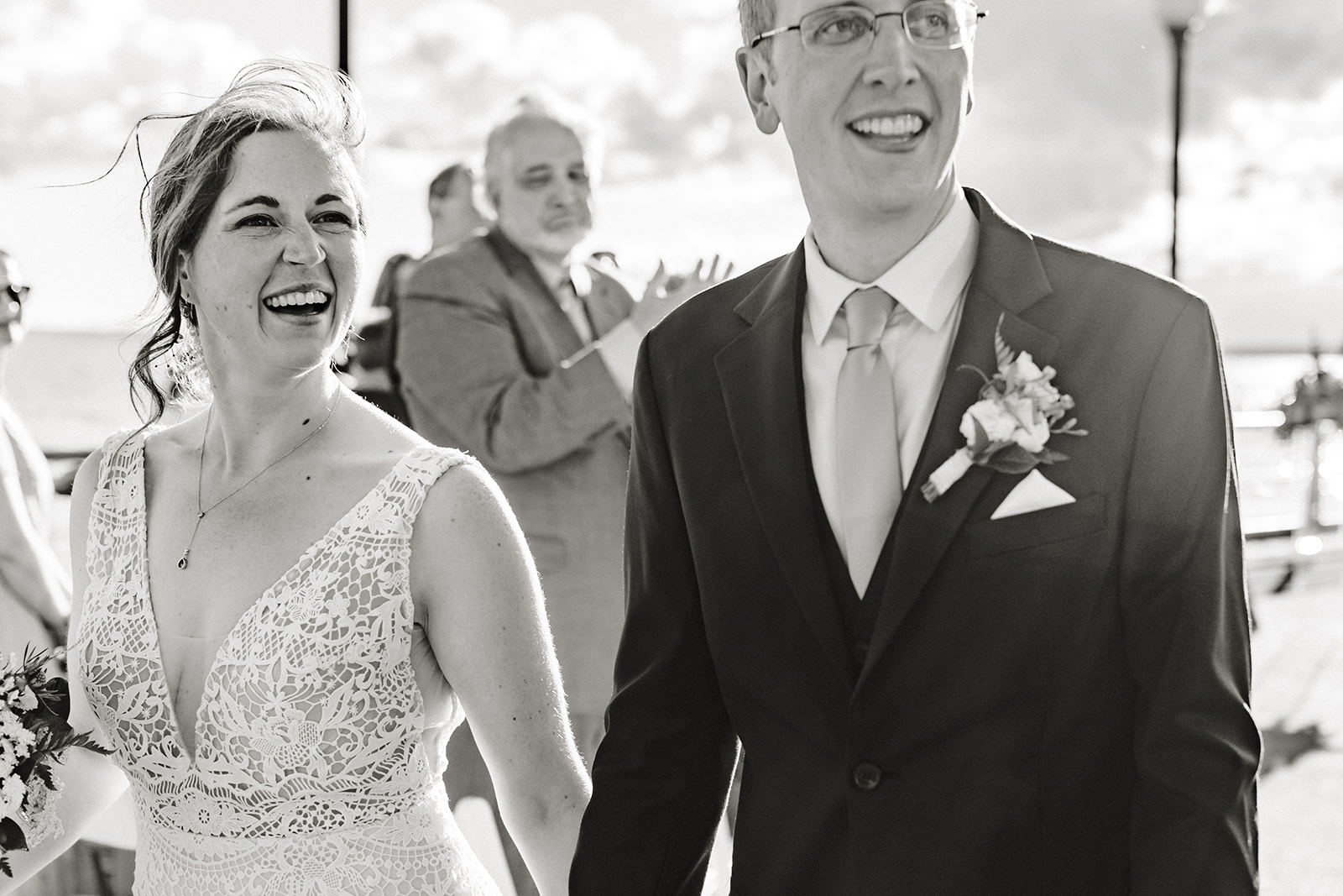 couple walks back up the aisle after their seattle aquarium wedding ceremony on the pier.