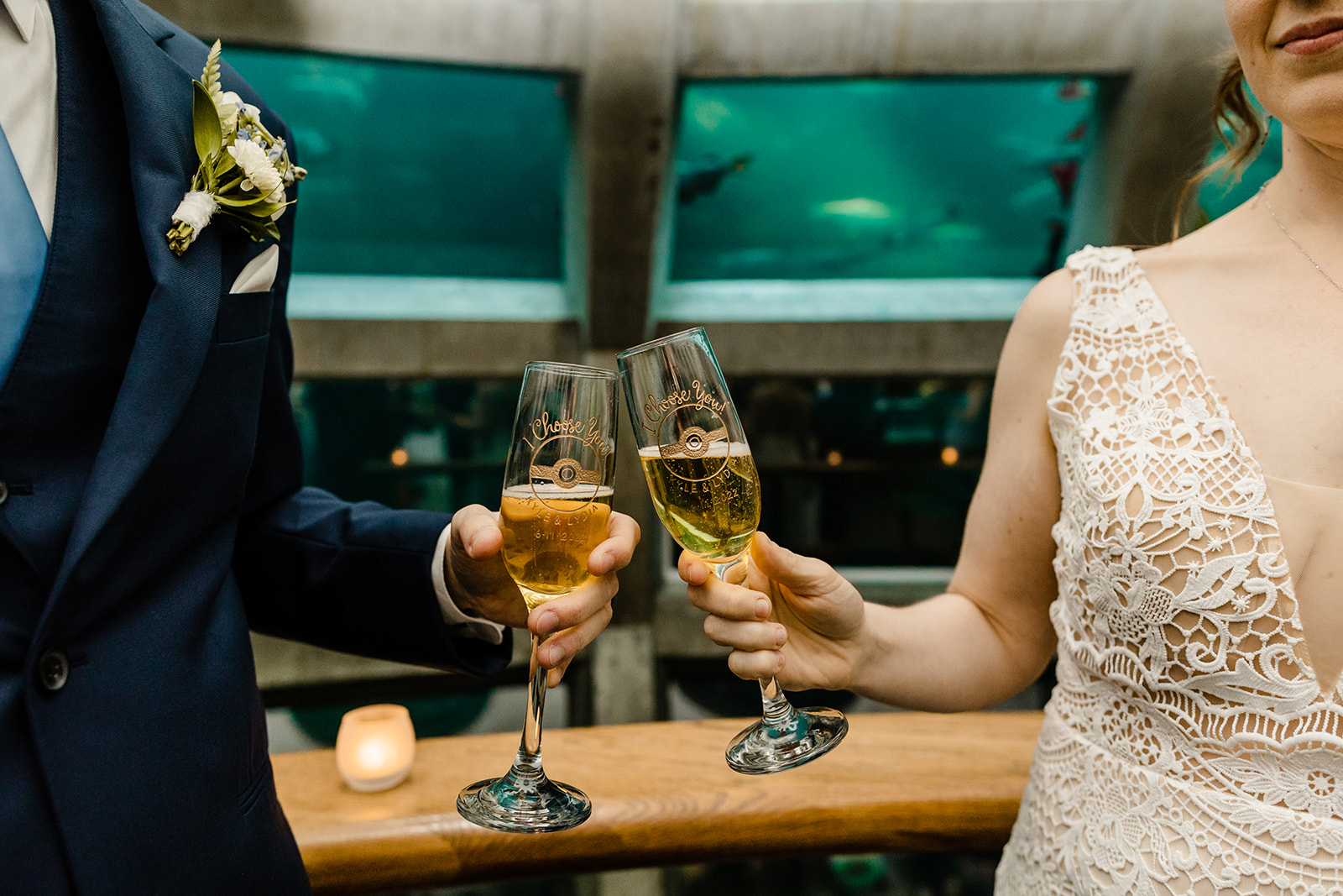 couple clinks engraved champagne glasses that feature a pokeball and the phrase "i choose you"