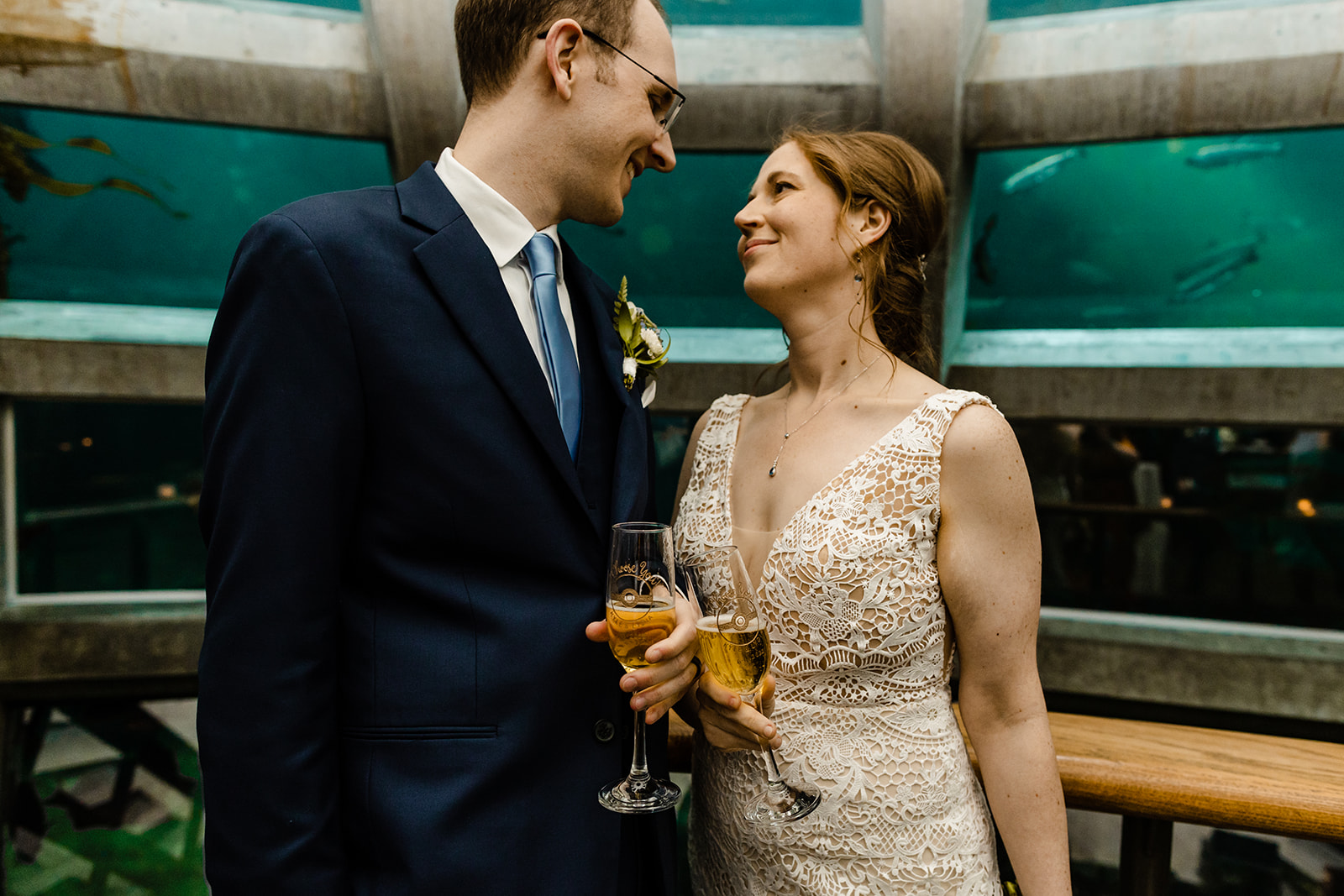couple clinks engraved champagne glasses that feature a pokeball and the phrase "i choose you"