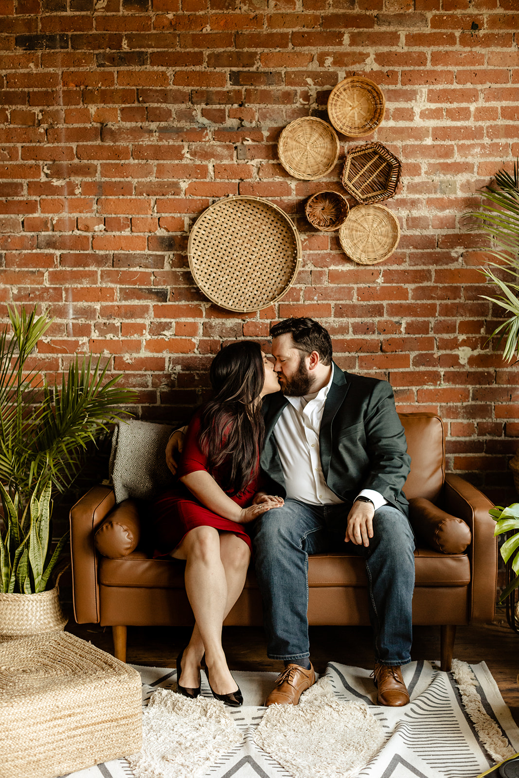 Couple shares a kiss on the couch.