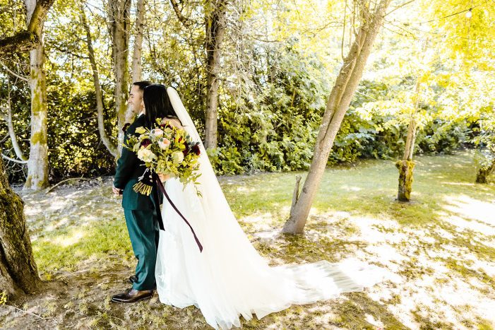 bride and groom first look in trees