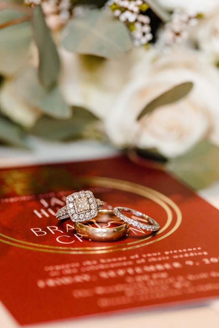 red invitation flat lay with rings