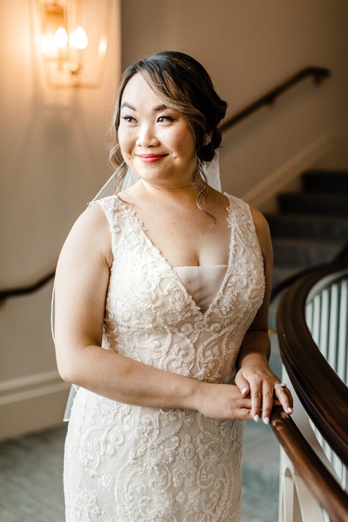 brides poses on staircase in front of seattle washington photogarphers