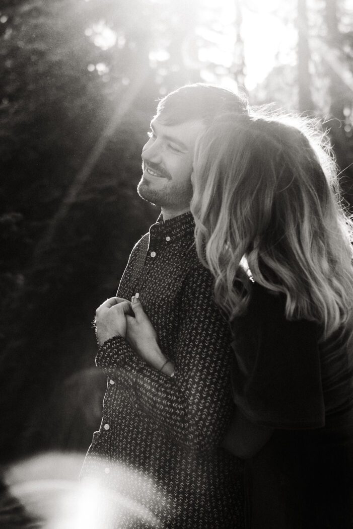 girl kisses boy on cheek in sun ray