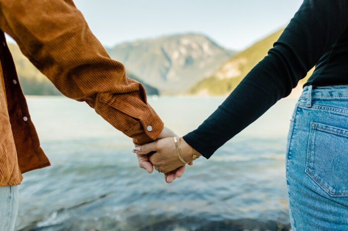 boy and girl hold hands during north cascades engagement photos
