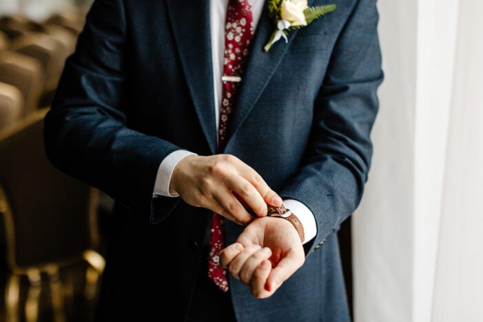 groom pulls on cuffs 