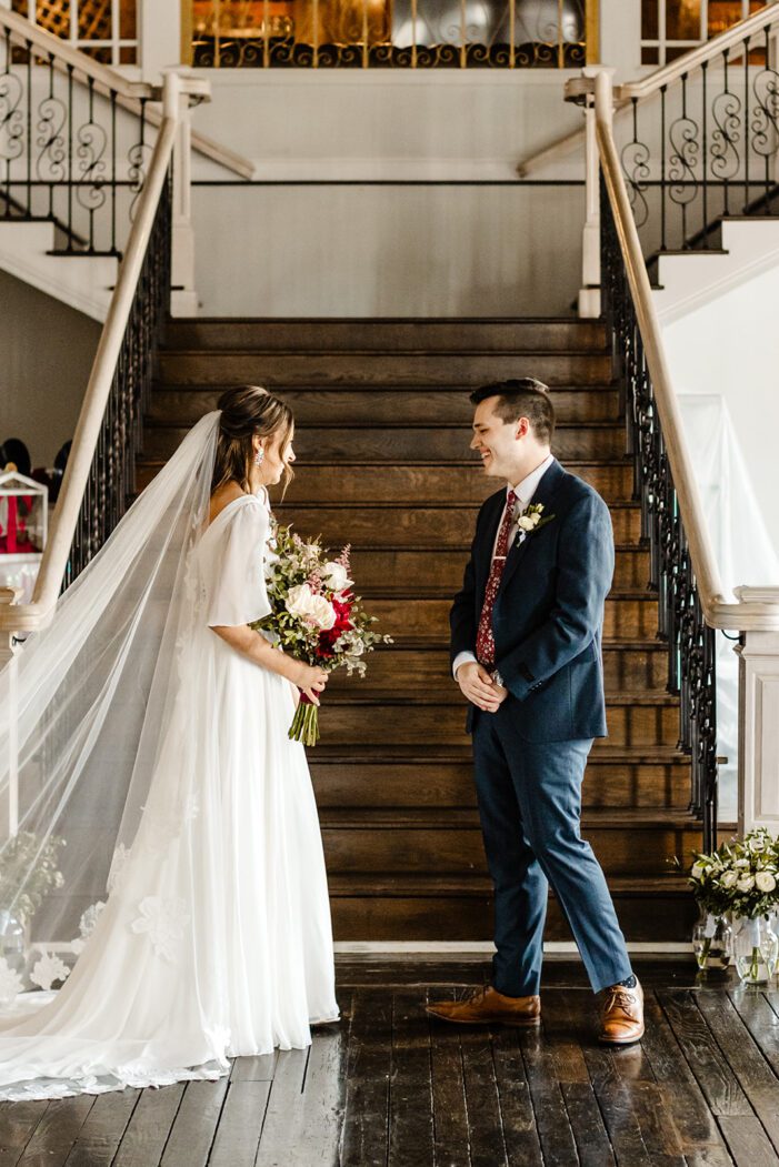 groom turns to see bride during first look during classic wedding photography