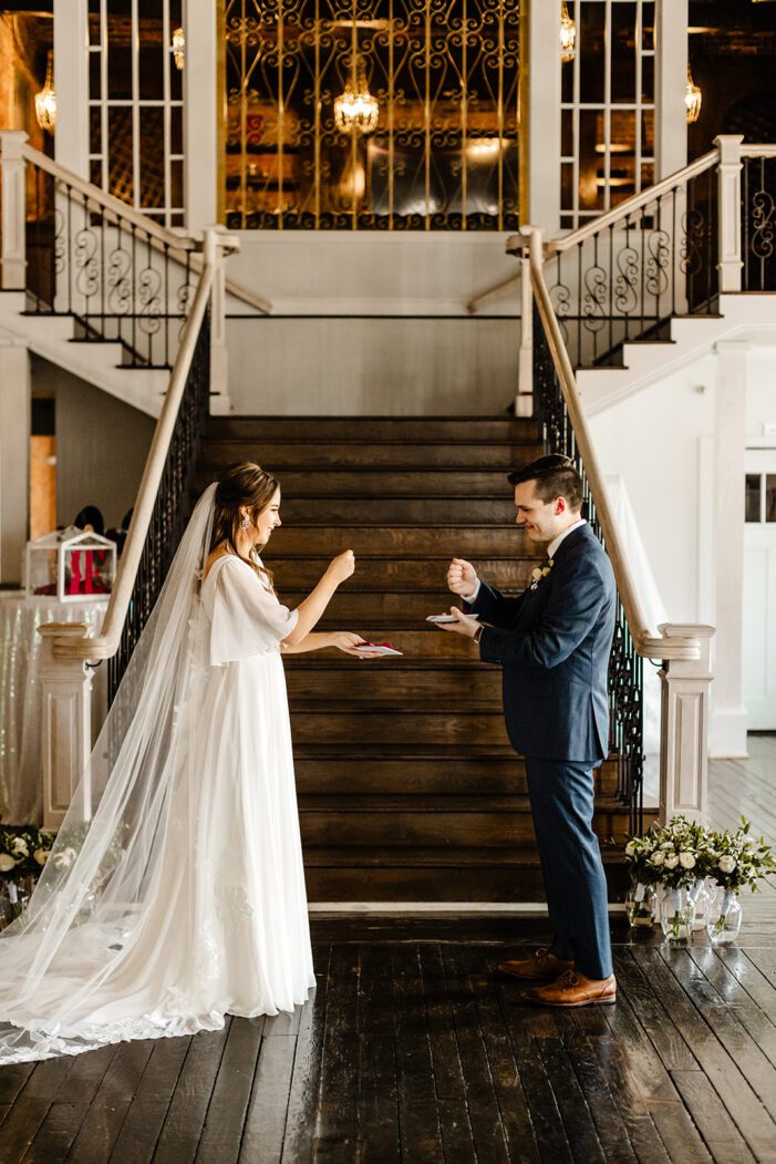 bride and groom play rock paper scissors