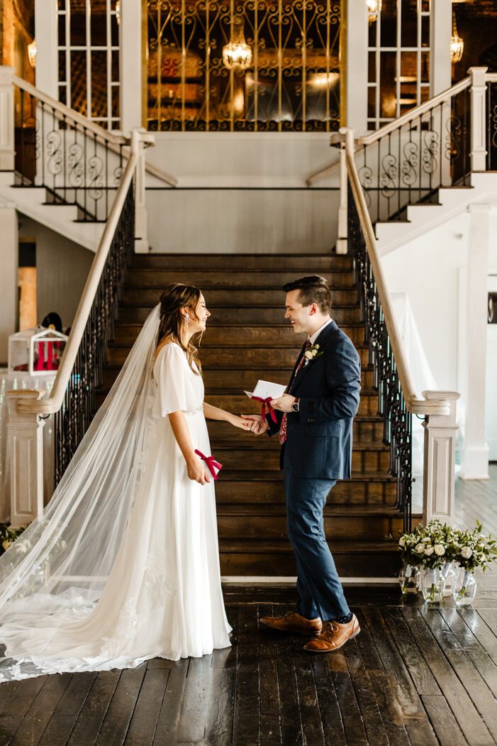 bride and groom read vows during classic wedding photography