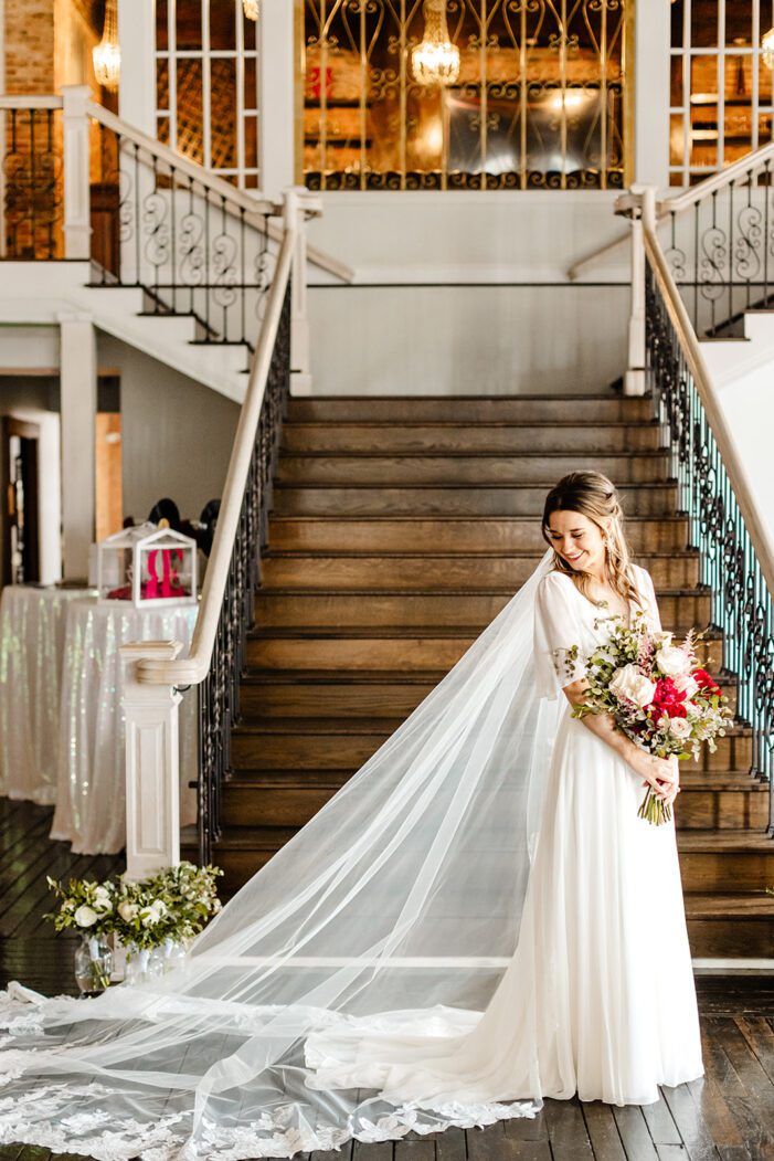 bride stands in front of stairs during classic wedding photography
