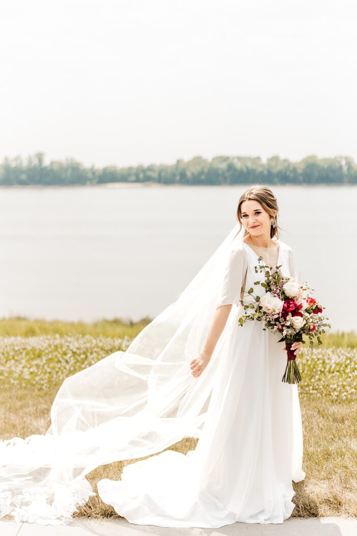 bride holds veil out behind her
