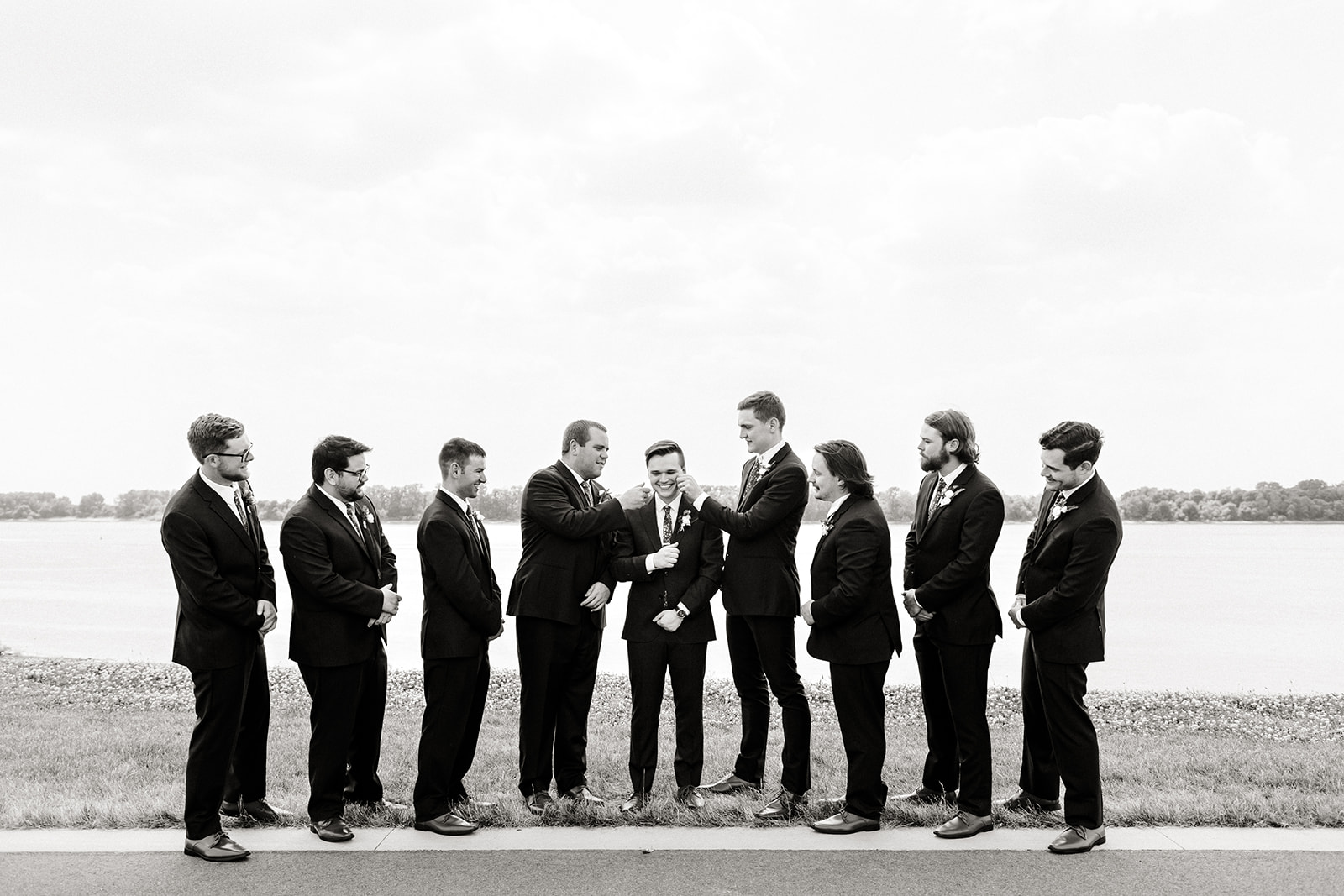 groom stands with groomsman