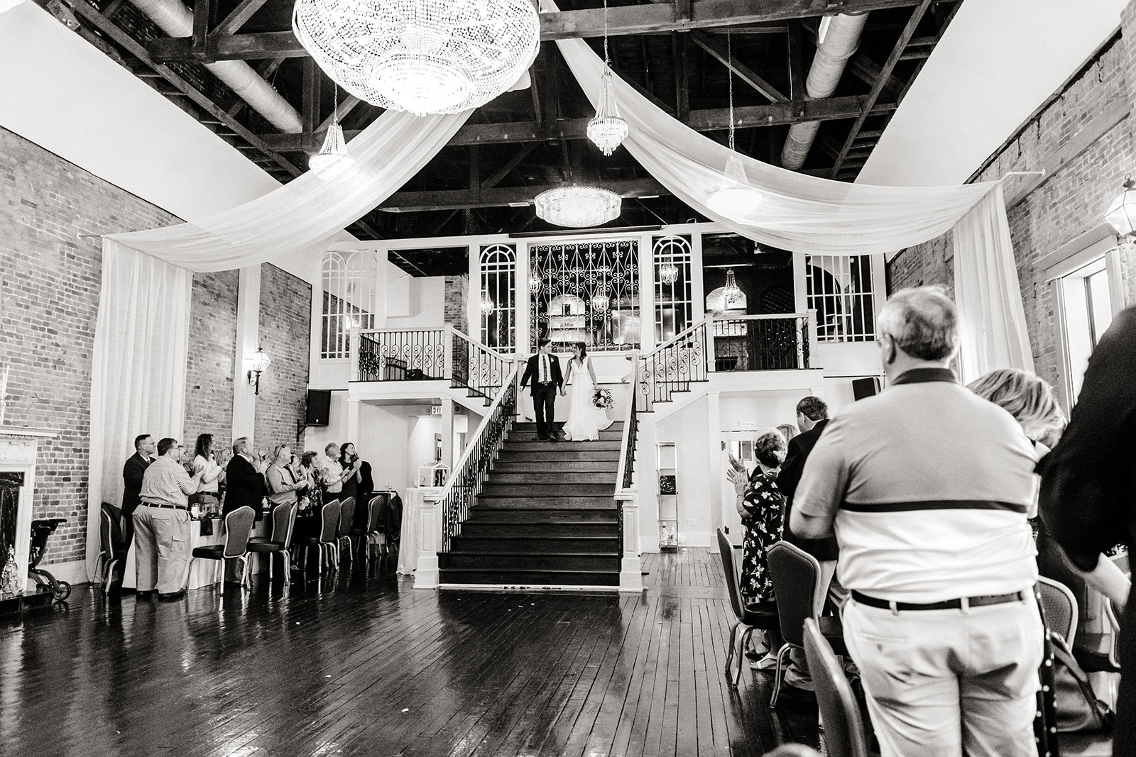 bride and groom enter reception via the stairs