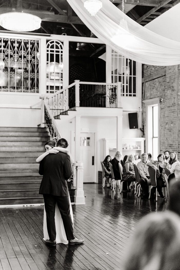 bride and groom share first dance in front of guests