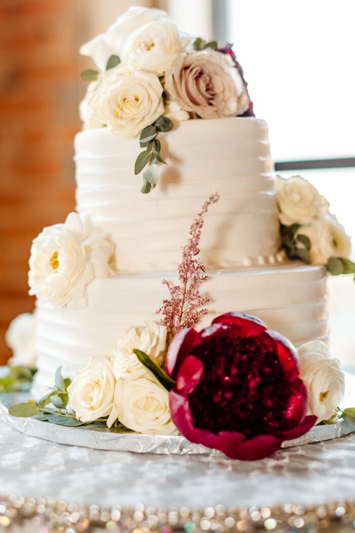 white cake with red and white flowers