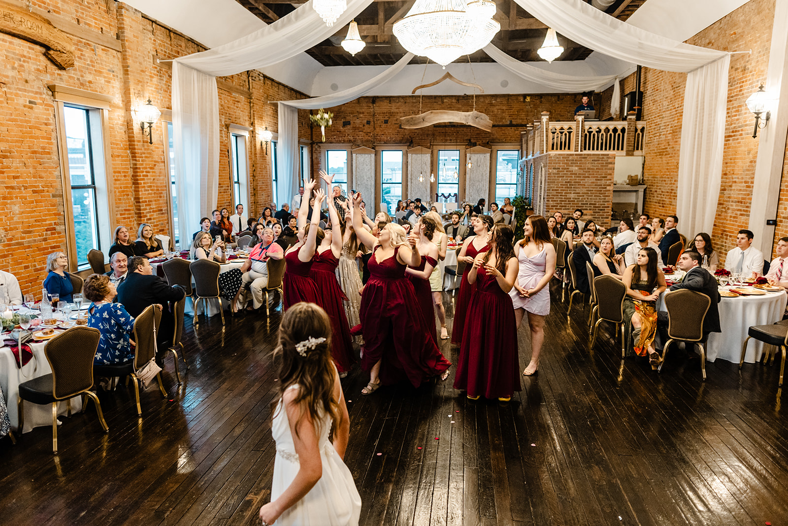 bride throws bouquet to group of women