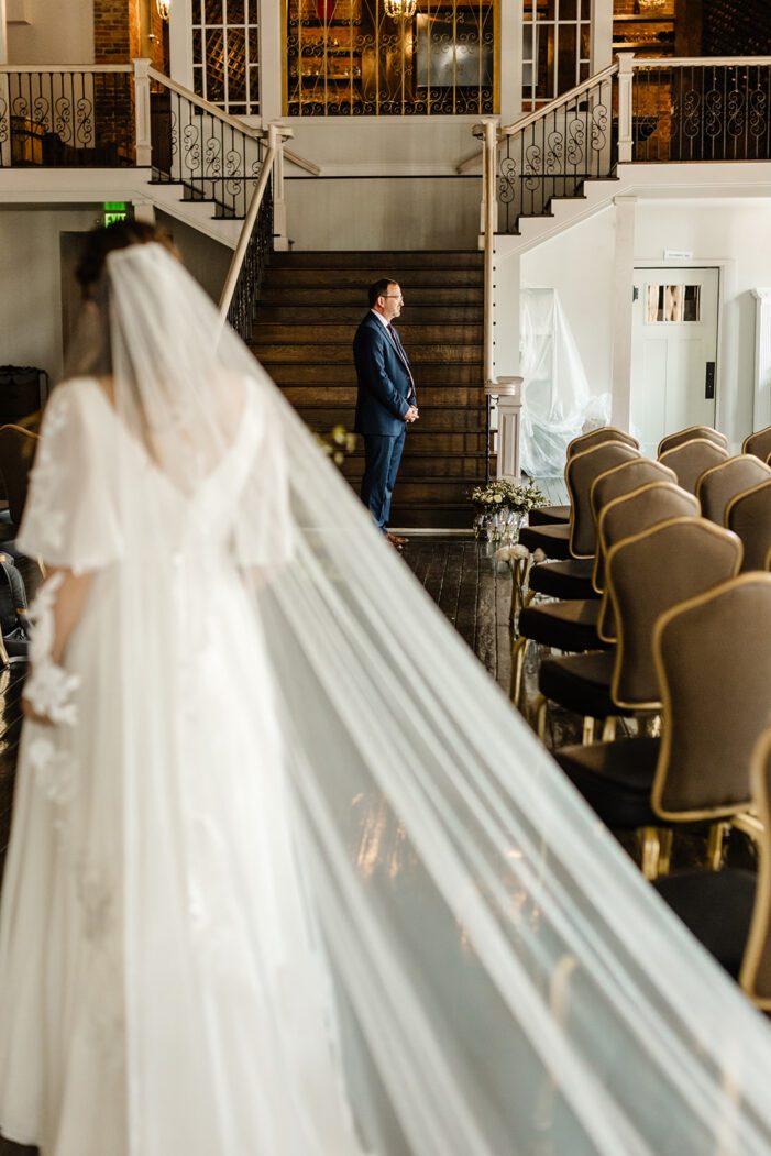 bride approaches dad for first look during classic wedding photography