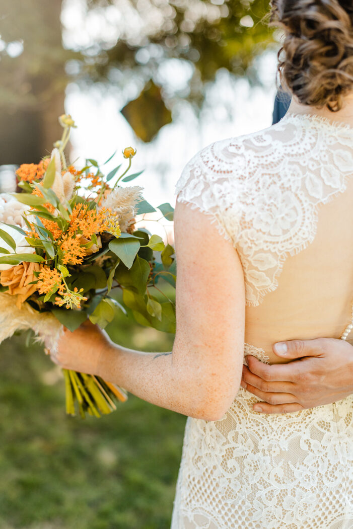 groom touches brides back