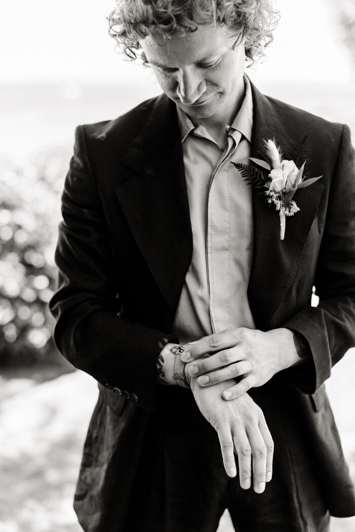 groom wears a blue coat and yellow shirt at ballard wedding