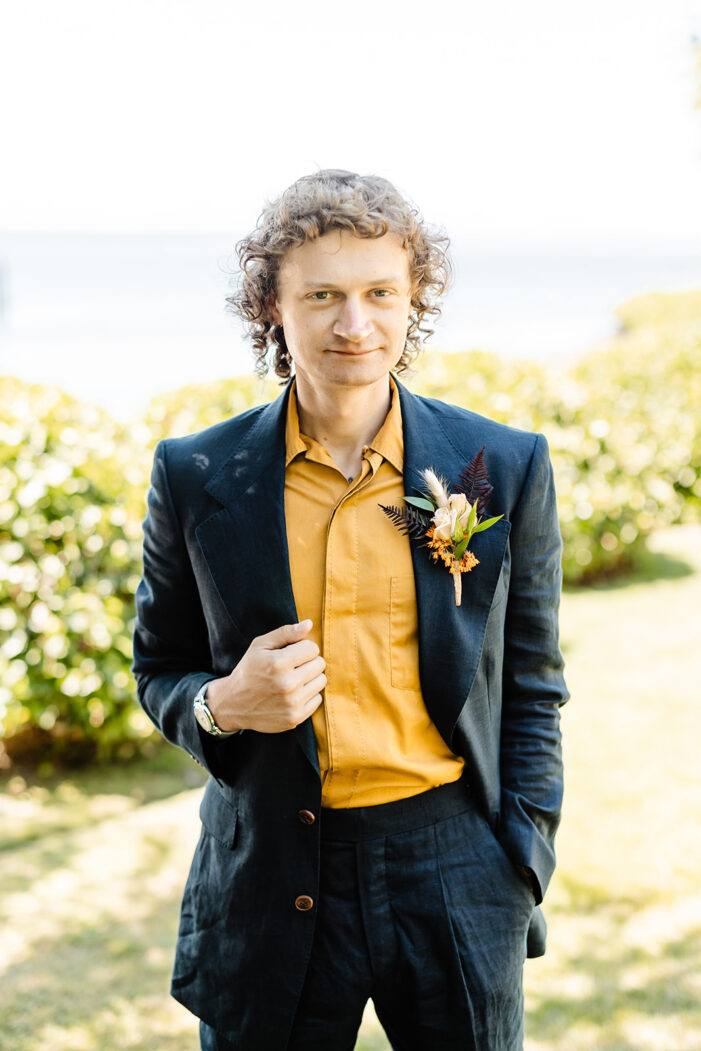 groom wears a blue coat and yellow shirt at ballard wedding