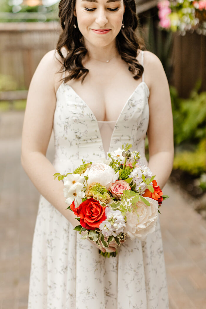 bride looks down at bouquet