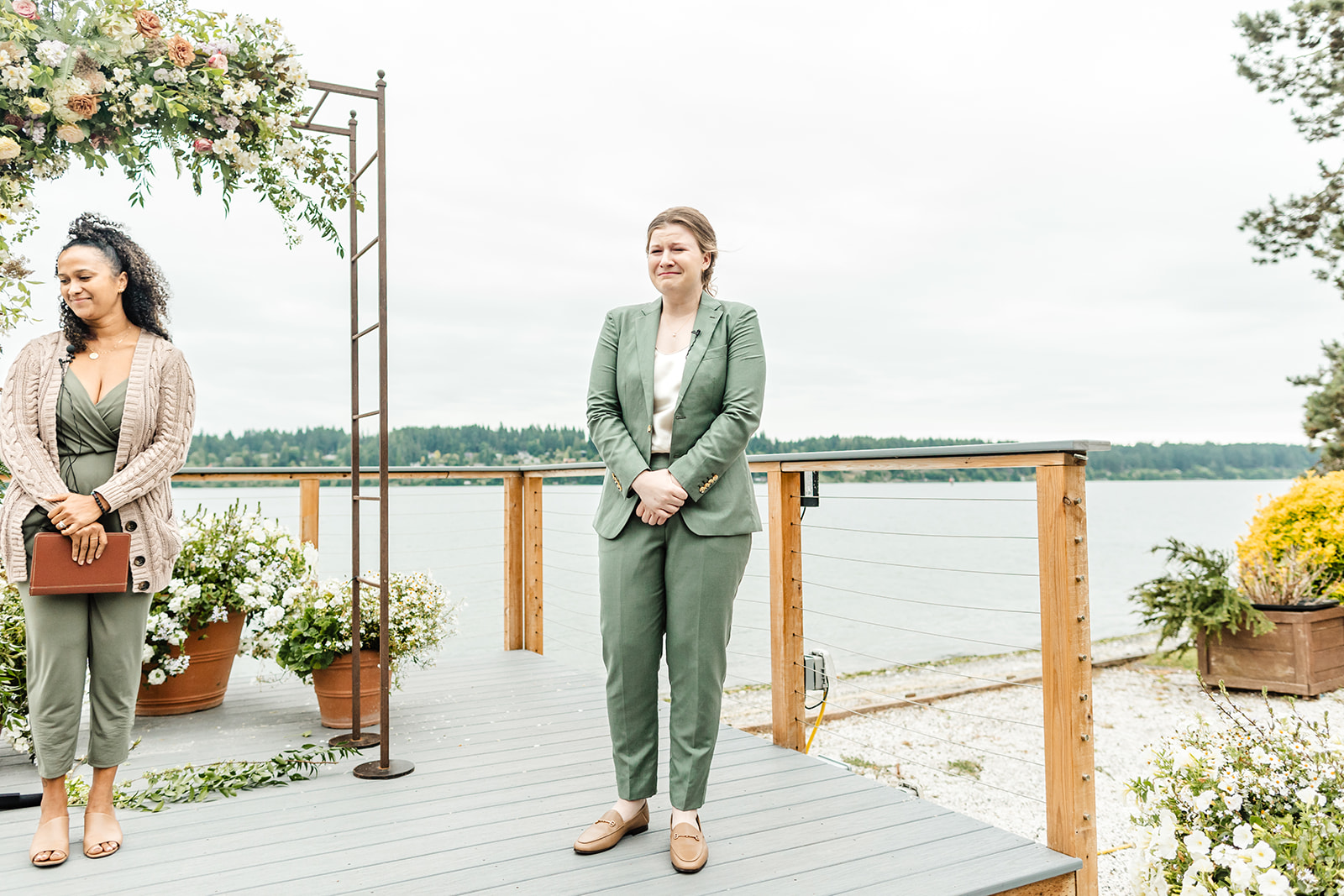 bride in green suit stand at alter at Kiana lodge wedding