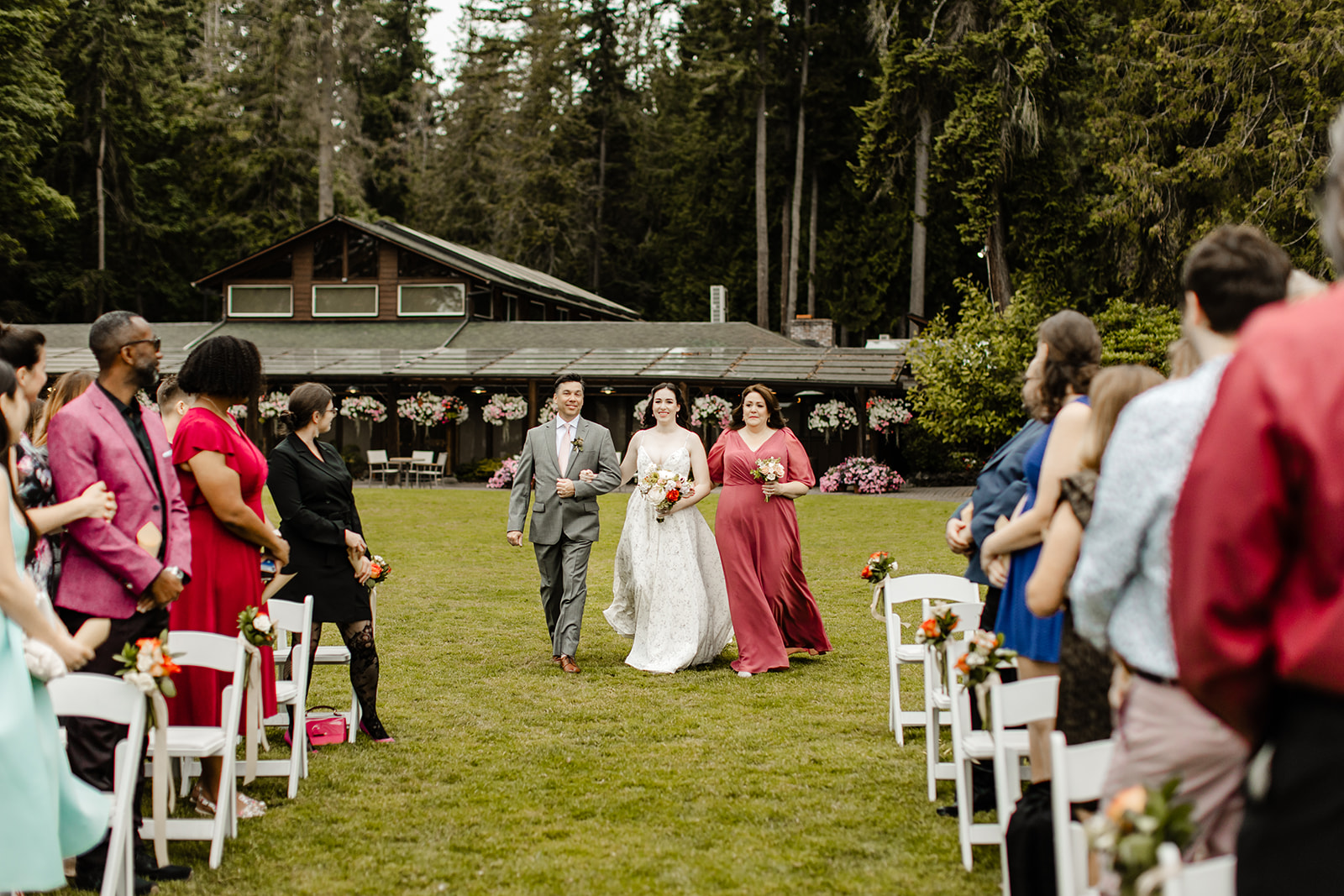 bride walks down aisle between two people