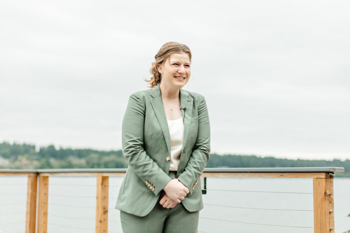 bride in green suit smiles