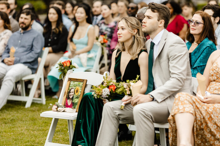 guests snuggle while watching ceremony at kiana lodge wedding