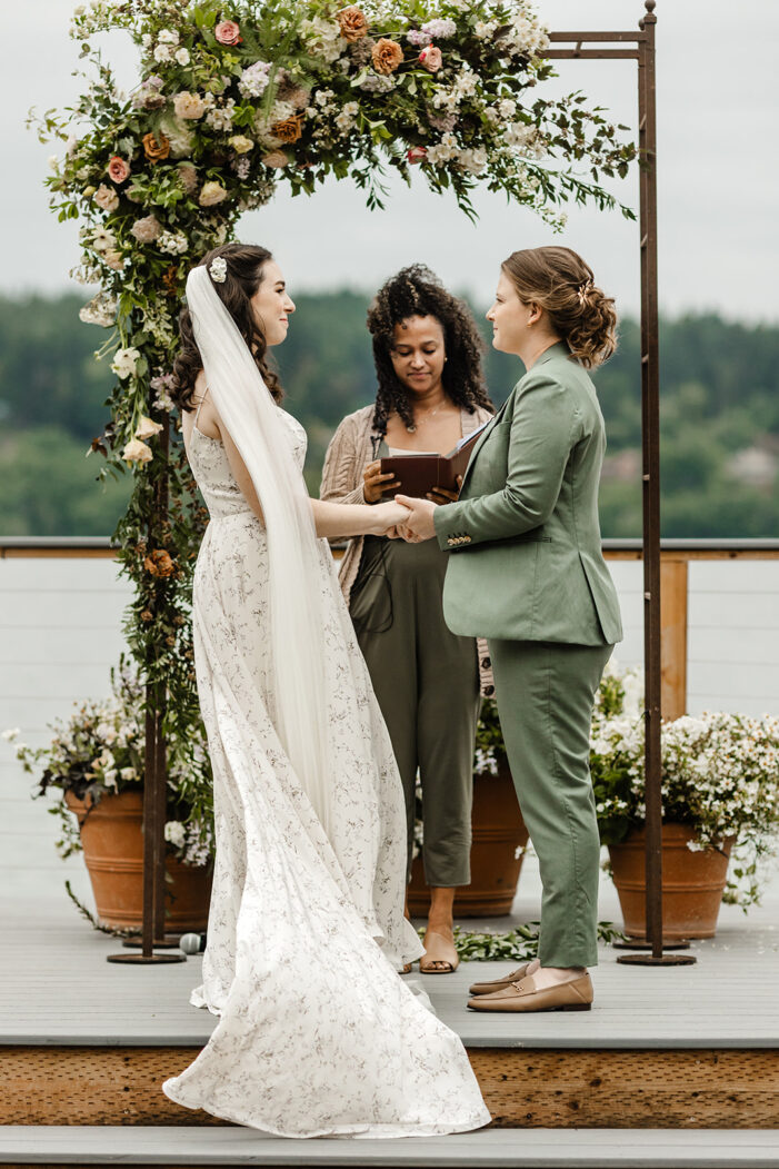 two brides stand at alter during kiana lodge wedding