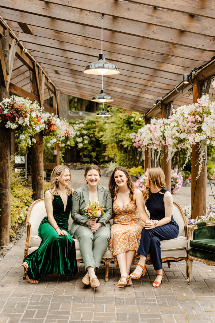 bride sits with bridal party on couch