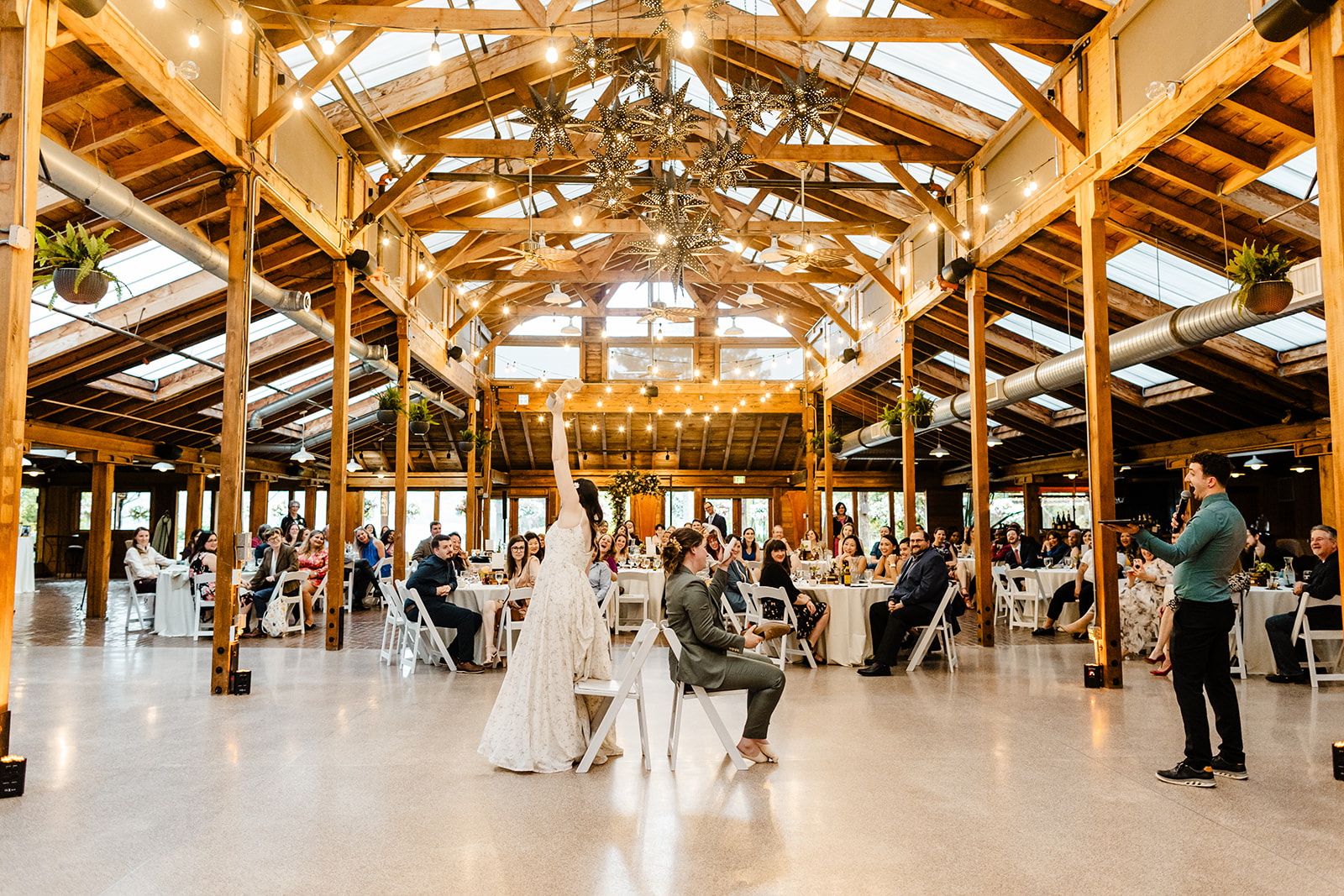 two brides play shoe game at wedding