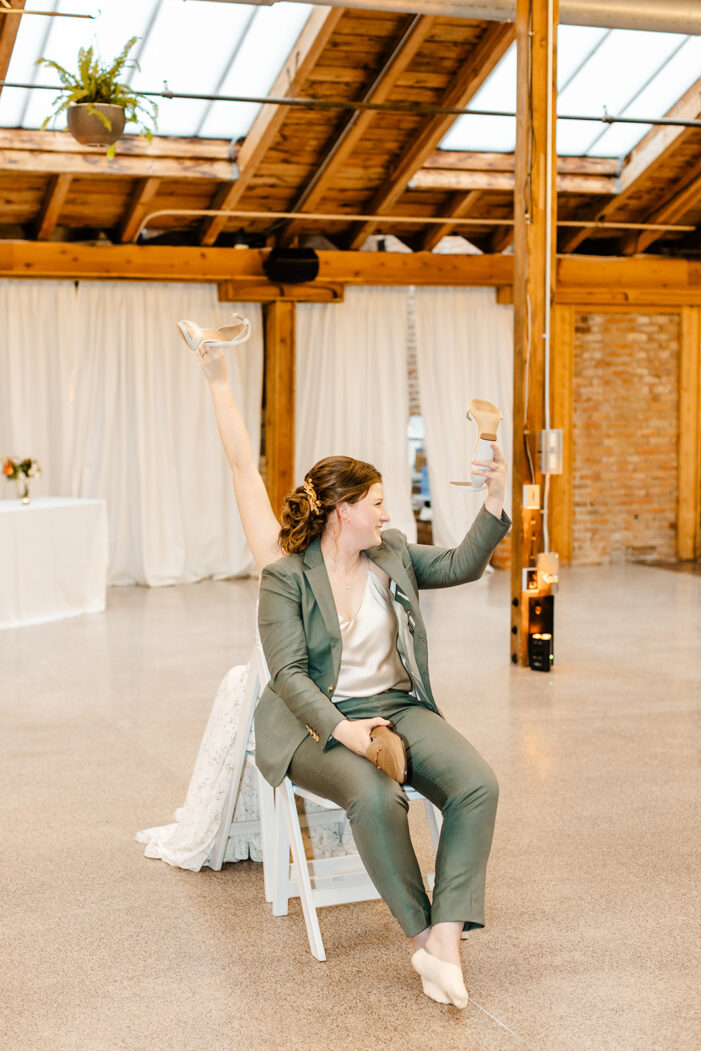 two brides play shoe game at wedding