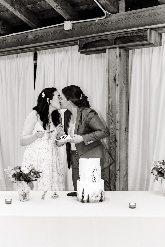 two brides cut cake at wedding